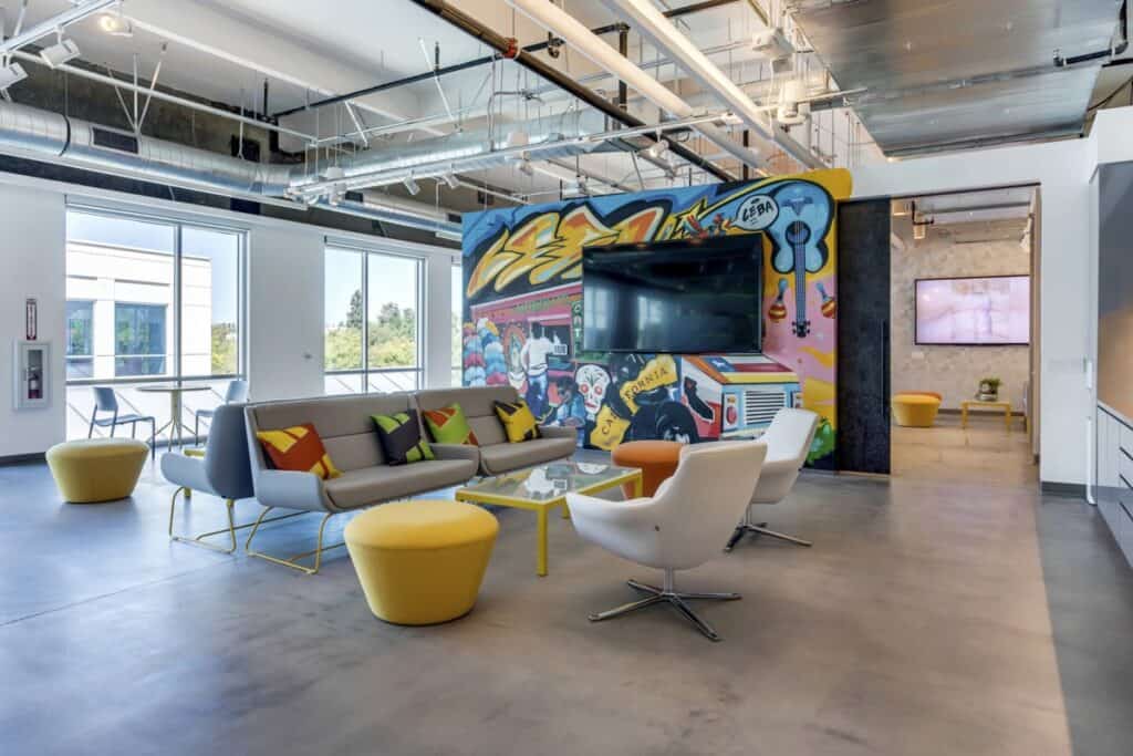 Modern office lounge with graffiti wall art.