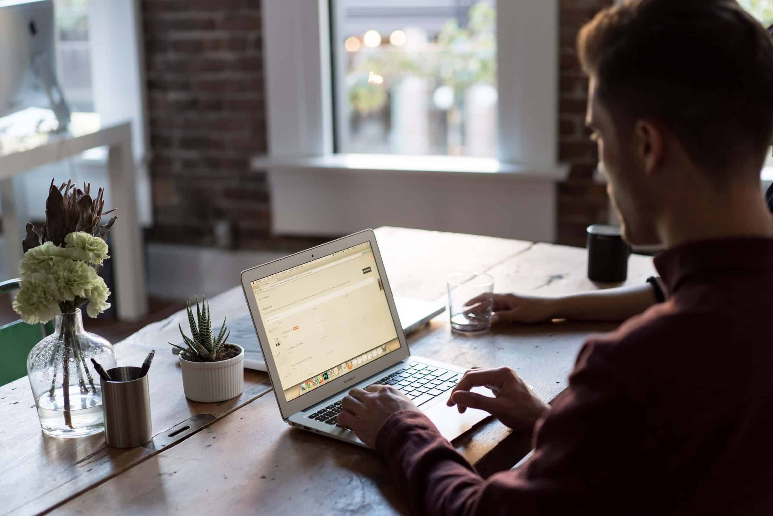 Person working on a laptop at desk.